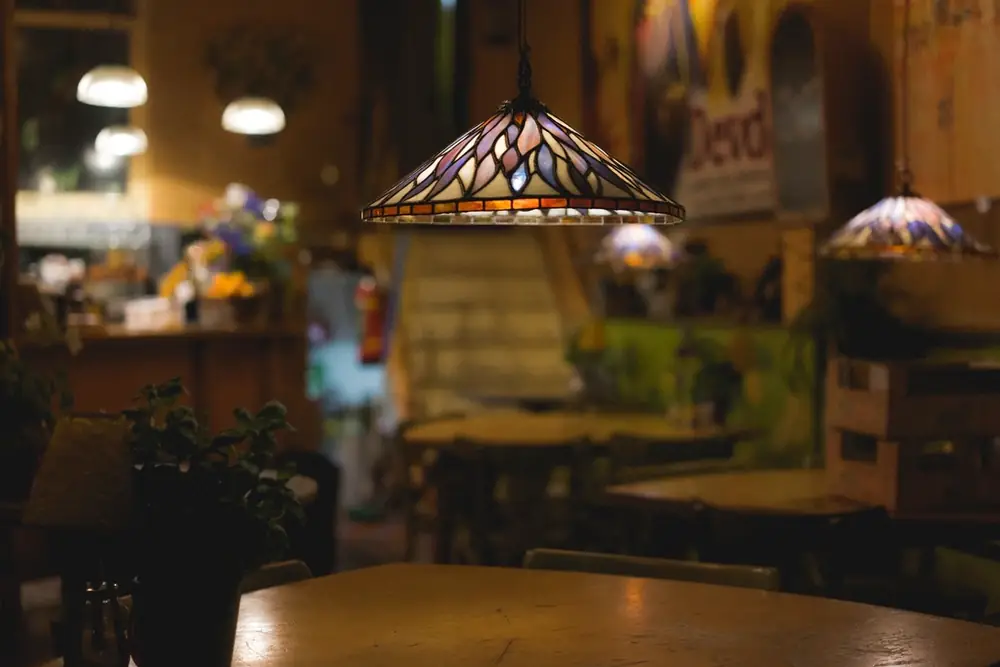 Warm, dim dining room with lamps