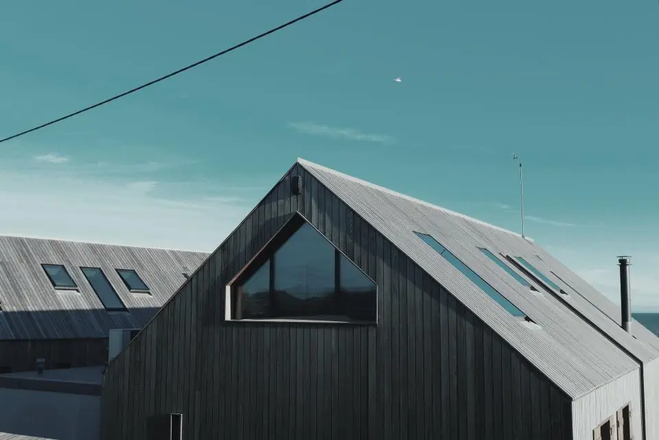 Modern dark wooden house with a steep roof
