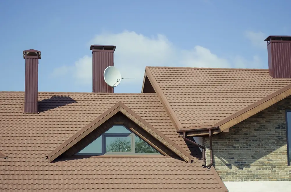 Brown tile roof with a dormer window and chimneys